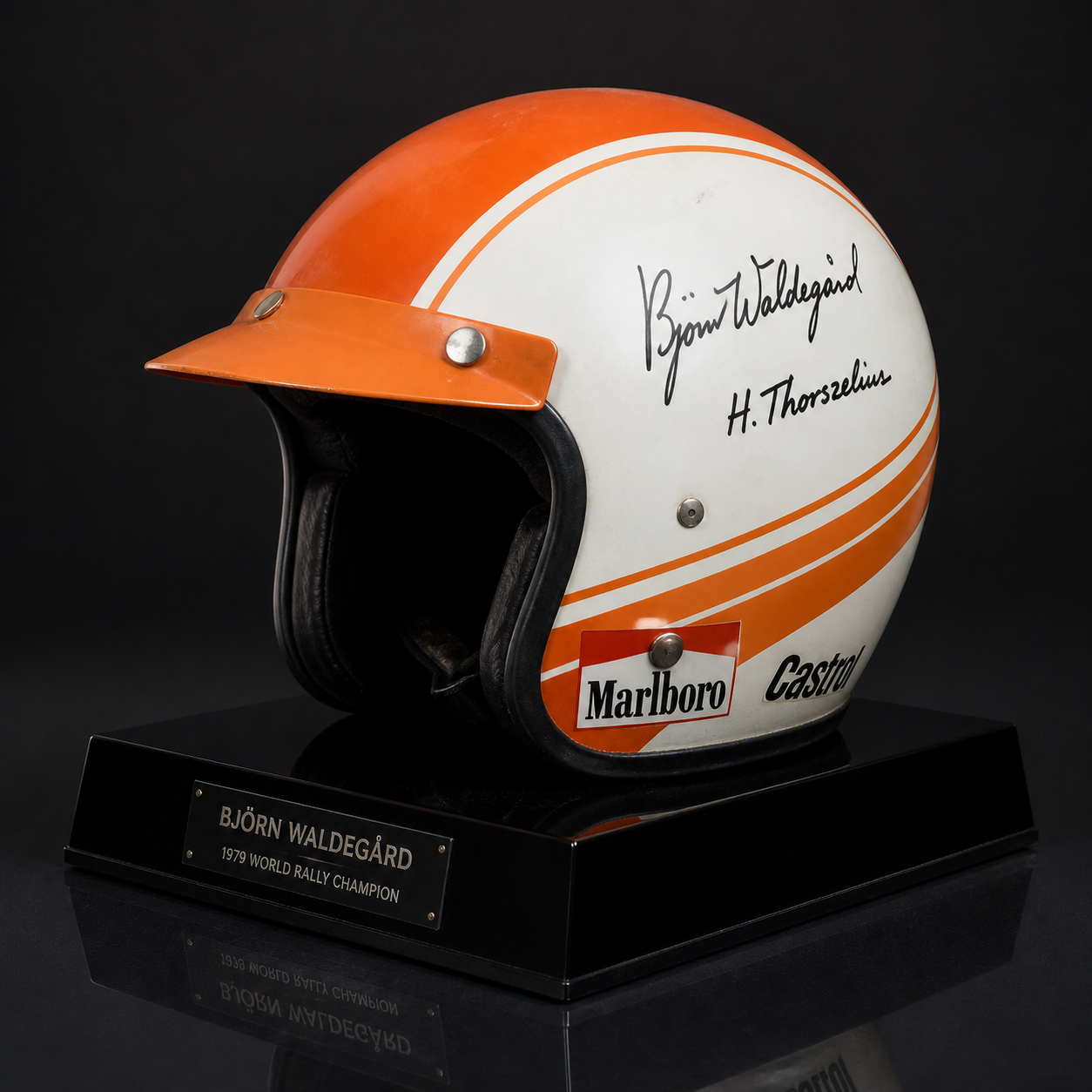 Signed 1970s rally helmet on a plinth